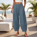 Detailed view of women's loose solid blue cropped harem pants in a beach setting - S / Bottoms / Aqua