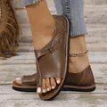 Detailed view of women's brown toe-loop flat sandals featuring a stylish buckle strap - Dark Brown