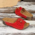 Détail de sandales compensées rouges à bout ouvert avec grande fleur décorative en cuir 3D - Rouge