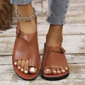 Close-up of brown leather toe-loop sandals with stylish buckle detail on wooden floor - 35 / Orange Red