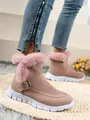 Close-up of stylish pink women's snow boots featuring soft faux fur trim and buckle - 36 / Pink