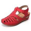 Close-up view of red vintage wedge sandals featuring hollow-out patterns and ankle strap - 35 / Red