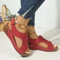 Close-up of red wedge sandals with hollow-out design and white stitching details - 36 / Red