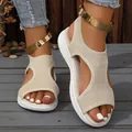 Close-up of beige fly-knit sandals with decorative gold metal ankle straps. - 36 / Beige