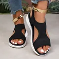 Close-up detail of women's black knit open-toe sandals with gold ankle straps - 36 / Black