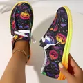 Detail view of women's Halloween pumpkin print canvas loafers with a vibrant gradient rubber sole - 36 / Black Skull