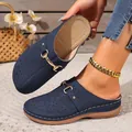 Detail of navy blue laser-cut platform mules with decorative metal buckle and stitching - 36 / Blue