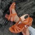 Detail view of brown chunky heel sandals with white stitching and buckle strap. - 36 / Brown
