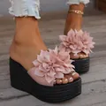 Detail view of pink flower platform sandals with thick woven soles for summer beach wear. - Pink