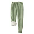 Detail shot of women's thick sherpa-lined joggers in sage green showing white fleece interior - S / Bottoms / Yellow-Green