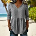 Detail showing the V-neck and peplum hem of a black and white gingham summer top - S / Tops / Black
