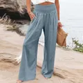 A close-up shot of blue wide-leg linen pants with a high elastic waist and button details - S / Bottoms / Light Blue