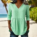Detailed view of a casual women's V-neck green gingham plaid top with a stylish peplum hem - S / Tops / Green