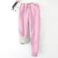 Detailed close-up view of pink winter joggers showing thick sherpa fleece lining. - S / Bottoms / Pink