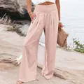 Casual high-waisted wide-leg cotton linen trousers for women in a breezy summer beach setting - Pink