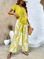 Summer two-piece set featuring yellow short sleeve top and floral print wide-leg pants - Yellow