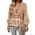 Detail view of Bohemian floral print blouse with V-neck tie and long puff sleeves. - 3XL / Tops / Apricot