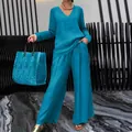Elegant women's turquoise two-piece travel set featuring a V-neck top and wide-leg trousers - Blue