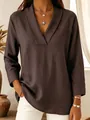 Close-up detail of a dark brown satin shawl collar V-neck blouse with elegant silk texture - Coffee