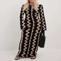 Detail view of a slim fit long sleeve maxi dress with black and beige wavy zigzag pattern - S / Dresses / Black Wave