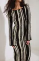 Detailed view of women's slim fit knitted dress with black and beige irregular stripes. - S / Dresses / Black Stripe