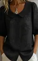 Close-up of vintage black Peter Pan collar shirt with textured floral pattern detail - S / Tops / Black