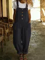 Ganzkörperansicht der schwarzen Vintage-Baumwoll-Leinen-Latzhose für Damen in einer Gasse - Schwarz