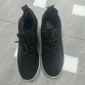 Macro view of black sneakers featuring sparkling rhinestone details and black laces - 36 / Black