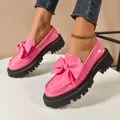 Stylish pink patent leather loafers with large bows and chunky black platform soles. - 35 / Pink