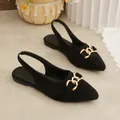 Black suede slingback flat sandals featuring a gold horsebit buckle and pointed toe. - 35 / Black