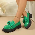 Stylish green platform loafers for women with a decorative bow and chunky black sole. - Green