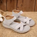 Detailed view of grey sporty platform sandals with woven straps and Velcro closure. - Gray