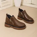 High-quality detail view of brown thick-sole Martin boots with stylish gold-tone zipper. - 36 / Brown