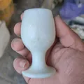 Hand holding a white Lantian jade goblet with natural green texture detail. - Milky White Texture Style (04k)