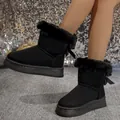 Stylish black snow boots with plush fur trim and back bow detail for winter warmth. - 36 / Black