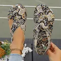 Close-up of ethnic style flat sandals with breathable paisley print fabric and closed-toe design - Black Floral