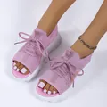 Close-up of pink platform knitted sports sandals with lace-up detail and white soles - 36 / Pink