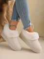 Detailed shot of white fuzzy snow boots with soft faux fur collar and suede finish. - 36 / Off White