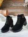Close-up detail of elegant black block heel ankle boots with golden heart buckle - 35 / Black