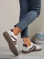Detail view of women's colorblock GAT sneakers with anti-slip textured rubber soles - 36 / Burgundy