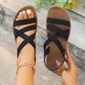 Elegant women's black elastic strap flat sandals with brown soles in Roman style - 36 / Black