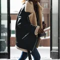 Detail shot of black faux suede biker jacket with shearling lining in snowy scene. - S / Tops / Black