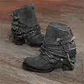 Macro detail of vintage charcoal suede ankle boots featuring braided strap accents. - 35 / Gray