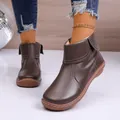 Detailed view of stylish brown leather ankle boots with side zipper and turnover collar design - 35 / Coffee