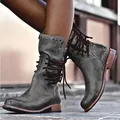 Close-up detail of vintage distressed grey leather boots featuring side lacing and studs - 38 / Gray