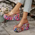Detailed view of colorful psychedelic pattern platform wedge sandals with clear straps - 36 / Rose Red