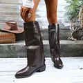 Stylish women's brown pointed-toe chunky heel pant-leg boots in a rustic outdoor scene - 36 / Brown Leather