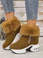 Close-up view of brown women's winter snow boots featuring warm fur trim and platform soles. - 35 / Camel