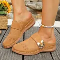 Close-up detail of women's tan mules featuring laser-cut patterns and a decorative metal buckle - 36 / Dark Brown