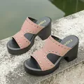 Pink studded platform mules featuring chunky high heels and chic open toe style - Pink